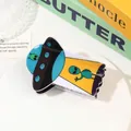 Detailed view of an acrylic UFO hair claw clip with colorful aliens on a stylish tray - Blue Alien UFO