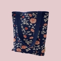 Detailed close-up of dark blue knit tote bag featuring beige and orange floral patterns - Navy Floral