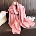 Detailed texture of pink satin scarf showing smooth glossy fabric and soft drape on top - Deep Pink