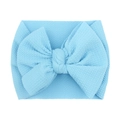 Detail of light blue textured knit baby headband featuring a soft decorative bow - Blue