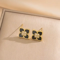 Golden clover earring set with black inlay and zircon crystal on luxury fabric - Gold Black Stud Earrings