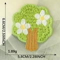 Embroidered green tree patch with white flowers, size dimensions shown on mesh background - Green Cartoon Tree