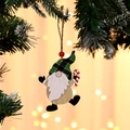 Detailed view of wooden Christmas gnome ornament with green plaid hat and candy cane - Candy Cane Style