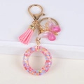 Pink tassel and glitter butterfly keychain with a sequin-filled resin circle charm - Letter O