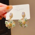 Détail des boucles d'oreilles fleur en cristal avec tiges S925 et pierres champagne - Tige en Argent 925 - Grappe de Fleurs Dorée et Verte