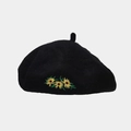 Close-up of vibrant yellow sunflower embroidery on black wool vintage beret - Black