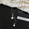 Detail of silver asymmetric double star necklace with snake chain on black background - Double Star Snake Chain Style / Silver