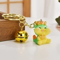 Cute green cartoon dragon keychain with gold ingot and bell for bag decoration - Ingot-holding Dragon Style