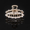 Detail view of a 5.5CM gold hair claw clip with elegant pearls and sparkling rhinestones - Half Rhinestone Half Pearl Oval 5.5CM Claw Clip