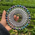 Macro detail of silver hollow-out metal wall art with colorful iridescent gemstones - Bright Silver Iridescent Black