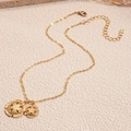 Minimalist gold tone necklace with round hollow flower pendants and textured shell details - Gold