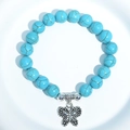 Blue turquoise beaded bracelet featuring a silver butterfly charm and metal connectors - Blue Turquoise Side Butterfly Charm