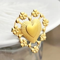 Golden heart ring with floral hollow frame and radial texture on a white plate - Hollow Heart Flower