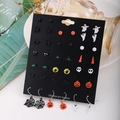 Close-up of Halloween earring set featuring ghosts, pumpkins, and bats on a black card - 20 Pairs Quirky Jack-o'-lantern Spider Set