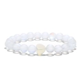 Detail of beaded bracelet with translucent white stones and a heart-shaped centerpiece - Moonstone Style