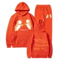 Orange Ivan Cornejo tracksuit set featuring astronaut graphics and Spanish text - Orange