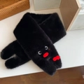 Detail of plush black scarf featuring a cute cartoon penguin face with red beak - Scarf / Red Billed Penguin - Black [Scarf]