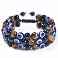 Three-layer braided tiger eye bead bracelet featuring a blue evil eye charm and adjustable cord - Yellow Tiger Eye + Obsidian + Evil Eye Bracelet