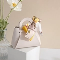 Elegant off-white leather gift box with decorative floral ribbon and handle - Off White With Silk Scarf