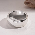 Close-up of a wide minimalist polished silver ring featuring a smooth mirror finish - Silver