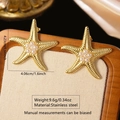 Gold starfish earrings in stainless steel with center pearl cluster and ribbed texture - Gold Pearl Starfish Earrings
