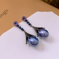 Detailed close-up of vintage flower drop earrings with blue crystal and pearl drops - Silver Earring Post - Purple