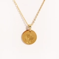 Macro detail of a gold oval pendant featuring an etched rose on polished titanium steel - Style 6 (XXL223)