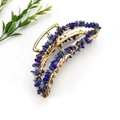Detailed macro view of handmade golden hair claw clip with blue lapis lazuli stones - Gold + Lapis Lazuli