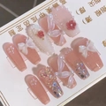 Close-up of pink press-on nails with 3D white bows, floral accents and pearl details - M / Pink White Gradient Pearl Butterfly Style (Includes 5-Piece Tool Set)