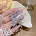 Silver geometric tassel earrings with marquise-cut crystals held by a model - Silver Colored Zircon Tassel (E0283 Silver)