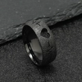 Macro shot of black matte stainless steel ring featuring heart cutout and ECG pulse line - Black EKG Heartbeat (8mm)