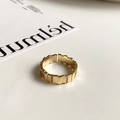 Macro detail of gold-plated textured open ring with inlaid rectangular cubic zirconia - Textured Pave
