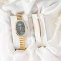 Elegant gold oval quartz watch with green dial and matching bracelet set on silk - Gold Watch Green Dial Set
