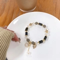 Detail of beaded sea star bracelet with lavender crystal beads and golden starfish charm - Black and Gray