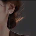 Close-up of elegant S925 silver letter C tassel earring line worn by a female model - Letter C