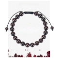 Detailed view of deep red garnet beads on adjustable black woven rope against card paper - Garnet Bracelet