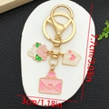 Detailed size view of the gold love keychain with rose and envelope charms, 7.7cm high - Pink Rose Heart Envelope Style (ER1287)