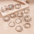 Set di 11 anelli geometrici argento con perla barocca e diverse texture metalliche opache - Argento