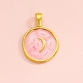 Macro detail of round alloy pendant featuring pink enamel finish and golden crescent moon charm - Pink Crescent
