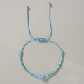 Pulsera ajustable hecha a mano con cuentas de mal de ojo en azul cielo y oro - Ágata Azul Trenzada
