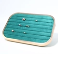 Detail view of emerald green velvet ring display tray with rose gold aluminum frame - Ring Row Tray
