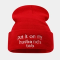 Detailed view of red knitted beanie with white embroidery text put it on my husband's tab - Red