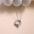 Close-up of a silver polished hollow pendant with a delicate box chain necklace - Silver (With Necklace) Q