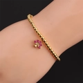 Gros plan d'un bracelet à billes dorées avec pendentif palmier serti de zircons violets - CB0587 Arbre Violet