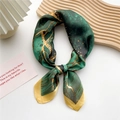 Silk scarf with emerald green and yellow marble pattern tied in a stylish knot - Green Stream