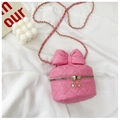 Detail of pink quilted leather bag featuring a large bow and floral zipper pull charms - Rose Red