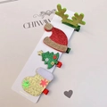 Close-up of a 4-piece Christmas hair clip set with reindeer, tree, and hat motifs - 4-Piece Glitter Christmas Hair Clip Collection