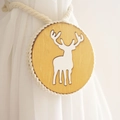 Detail view of wooden curtain tieback with white deer motif and braided cotton rope - Yellow Reindeer Style