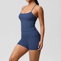 Detail of navy blue yoga set showing side pockets on high-waist shorts and thin straps - S / Navy Blue