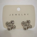 Elegant silver flower stud earrings in stainless steel on a beige jewelry display card - White K Four-Petal Flower (3690)